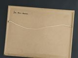 a brown box with a string on it on a black surface