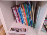 a white book shelf with a bunch of books on it