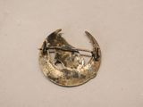 an image of a gold broochle with a crescent on it