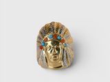 a close up of a gold ring with an indian head on it