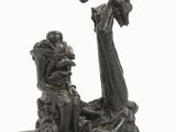 statue représentant un homme et une femme assis sur un banc, avec un oiseau en vol