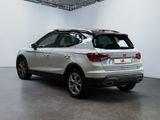 an image of a silver car parked in a showroom