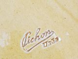 a close up of a yellow plate with a logo on it