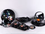 beaucoup d'assiettes et de bols noirs sur la table