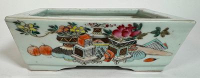 a small planter with flowers and fruit in it