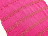 close up of a pink pillow with a striped design on it