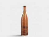 a brown vase sitting on top of a table next to a white wall