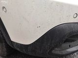 a close up of a car ' s front bumper and fender