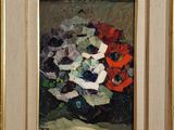 tableau représentant un vase de fleurs dans un cadre doré posé sur une table