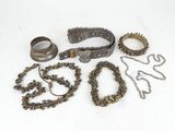 several pieces of jewelry are laying out on a white surface