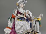 an image of a figurine of a woman and a man sitting on a bench