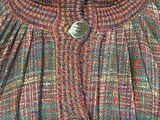a close up of a woman ' s jacket with buttons on it