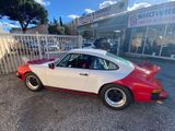 an image of a red and white car parked in front of a shop