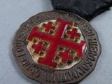 a medal with a red cross on it on a table