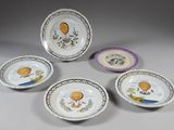 six plates with hot air balloons painted on them sitting on a table