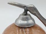 a metal object that is on top of a vase