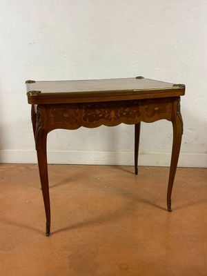 a small wooden table with a marble top on it