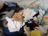 a pile of clothes on a bed in a room