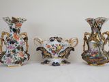 three vases are sitting on a white surface with a white background
