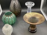 three vases and a bowl sitting on a table
