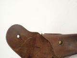 a close up of a brown leather shoe with holes in it