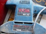 a close up of a corded sander on a table
