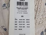 a price tag on a white dress with blue flowers on it