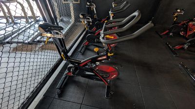 many bikes that are lined up in a room