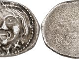 une pièce d'argent sur laquelle figure un visage au recto et un autre au verso
