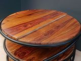 a stack of three wooden tables with metal legs