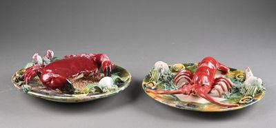 pair of ceramic crab and lobster dishes on plates