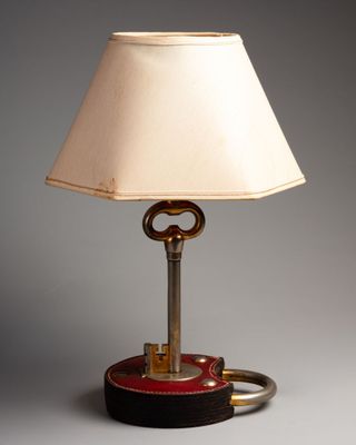 an image of a lamp with a key on it on a table
