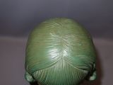 a green toy that is sitting on a table