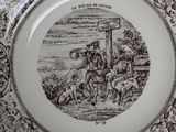 a black and white plate with a picture of a man on a horse