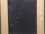 an old picture frame with a chalk board attached to it