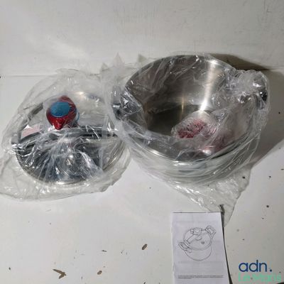 a silver bowl and a silver bowl on a white table