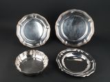 three silverplated dishes on a black background
