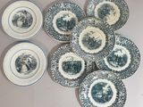 several plates with blue and white designs are arranged on a table