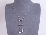 a white pearl and diamond necklace on a mannequin mannequin