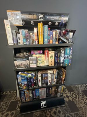 a book shelf that has a lot of games on it