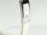 a white wrist watch with a black face on a white bracelet