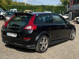 a black car that is parked in a parking lot