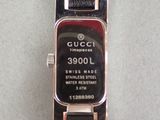 a gucci watch that is sitting on a table