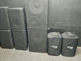 many speakers and bags sitting on the floor next to each other
