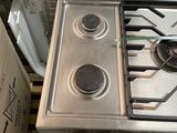 a silver stove top with two burners and a stove top oven