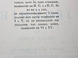 a close up of a page of a book with a clock on it