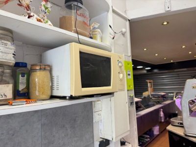 a microwave sitting on top of a shelf in a kitchen