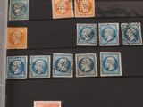 a lot of stamps that are on display in a glass case
