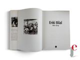 an open book with a black and white photo of people in a living room
