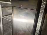 a silver refrigerator that is inside of a kitchen